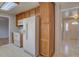 Well-lit kitchen featuring white appliances, wood cabinets, and a pass-through to other rooms at 6272 S Garfield Dr, Centennial, CO 80121