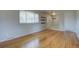 Open living area with wood floors, a large window, and freshly painted walls, creating a bright and airy atmosphere at 6272 S Garfield Dr, Centennial, CO 80121