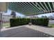 Private patio area surrounded by lush green hedges and covered with a striped awning at 6272 S Garfield Dr, Centennial, CO 80121