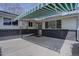Charming patio space outside the home featuring concrete flooring and a striped awning at 6272 S Garfield Dr, Centennial, CO 80121