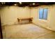 Partially finished basement with carpeted area, window and insulated walls ready for personalization at 18121 E Adriatic Pl, Aurora, CO 80013