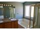 Bathroom featuring a soaking tub, shower, and a vanity with ample counter space and storage at 18121 E Adriatic Pl, Aurora, CO 80013