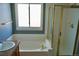 Bathroom featuring a soaking tub, shower with glass door, and a granite-look vanity at 18121 E Adriatic Pl, Aurora, CO 80013