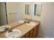 Well-lit bathroom features double sinks and a large mirror, offering a functional space at 18121 E Adriatic Pl, Aurora, CO 80013