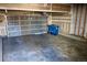 Spacious two-car garage with concrete floor and insulated garage door, ideal for parking and storage at 18121 E Adriatic Pl, Aurora, CO 80013