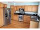 Charming kitchen featuring stainless steel appliances and warm wood cabinets at 18121 E Adriatic Pl, Aurora, CO 80013