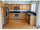 Charming kitchen featuring stainless steel appliances and warm wood cabinets at 18121 E Adriatic Pl, Aurora, CO 80013