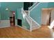 Bright living room featuring stairs, fresh paint and hardwood floors at 18121 E Adriatic Pl, Aurora, CO 80013