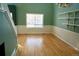 Bright living room featuring large windows, fresh paint and hardwood floors at 18121 E Adriatic Pl, Aurora, CO 80013