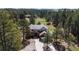 Spacious home nestled among mature trees and landscaping, with an inviting driveway at 11790 Huckleberry Dr, Franktown, CO 80116