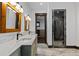 Bathroom featuring double vanity with stone countertop and walk-in shower at 11790 Huckleberry Dr, Franktown, CO 80116