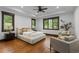 Comfortable bedroom with wood floors, large windows, and tray ceiling at 11790 Huckleberry Dr, Franktown, CO 80116