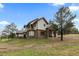 Elegant two-story home with stone accents, a private balcony, and verdant surroundings at 11790 Huckleberry Dr, Franktown, CO 80116