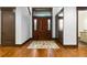 Elegant foyer featuring hardwood floors, a grand wooden door, and stylish accents at 11790 Huckleberry Dr, Franktown, CO 80116