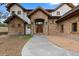 Inviting stone and stucco home with a grand wooden front door and charming entryway at 11790 Huckleberry Dr, Franktown, CO 80116