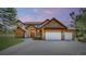 Stunning stone and stucco home with a three-car garage and lush landscaping at 11790 Huckleberry Dr, Franktown, CO 80116
