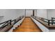 Hallway with wooden floors and dark wooden railings at 11790 Huckleberry Dr, Franktown, CO 80116