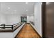 Long hallway with wooden floors, white walls, and natural light at 11790 Huckleberry Dr, Franktown, CO 80116