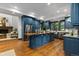 Large kitchen with center island, stainless appliances, and wood floors at 11790 Huckleberry Dr, Franktown, CO 80116