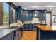 Kitchen with custom cabinets, granite countertops, and stainless steel appliances at 11790 Huckleberry Dr, Franktown, CO 80116