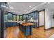 Spacious kitchen with blue cabinets, wood island, and stainless steel appliances at 11790 Huckleberry Dr, Franktown, CO 80116