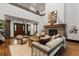 Bright living room featuring a stone fireplace, hardwood floors, and stylish furnishings at 11790 Huckleberry Dr, Franktown, CO 80116
