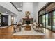 Living room featuring high ceiling, stone fireplace and modern decor at 11790 Huckleberry Dr, Franktown, CO 80116
