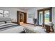 Spacious main bedroom with wood floors, private balcony, and walk-in closet at 11790 Huckleberry Dr, Franktown, CO 80116