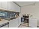 Bright kitchen featuring white cabinets, subway tile backsplash, and stainless steel oven at 2401 W 39Th, Denver, CO 80211