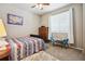 Cozy bedroom features a ceiling fan, a large window and room to play or study at 17056 E 111Th Ave, Commerce City, CO 80022