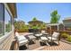 Outdoor deck with an umbrella-covered table, lounge furniture, and space to relax outdoors at 17056 E 111Th Ave, Commerce City, CO 80022