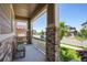 Inviting front porch featuring stone pillars, ample seating, and views of the neighborhood at 17056 E 111Th Ave, Commerce City, CO 80022