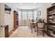 Comfortable home office featuring large windows for natural light, hardwood floors and built-in shelving at 17056 E 111Th Ave, Commerce City, CO 80022