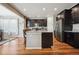 Modern kitchen featuring dark wood cabinets, stainless steel appliances, granite counters, and a center island at 17056 E 111Th Ave, Commerce City, CO 80022