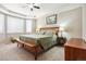 Spacious main bedroom features a ceiling fan and a large bed with a wooden frame and a bench at 17056 E 111Th Ave, Commerce City, CO 80022