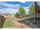 Spacious backyard with lawn, trees, and a wooden fence, perfect for outdoor activities and privacy at 7598 Jared Way, Littleton, CO 80125