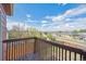 A balcony overlooking the neighborhood provides views of well-kept houses and beautiful sky at 7598 Jared Way, Littleton, CO 80125