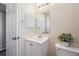 Bathroom featuring a white vanity, and toilet with an open mirror, and a towel hanger at 7598 Jared Way, Littleton, CO 80125