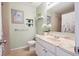 Bathroom with pastel pink tile, a shower/tub combo, and decorative wall art at 7598 Jared Way, Littleton, CO 80125