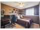 Bedroom featuring a daybed, brown walls with corner shelves, and lots of natural light at 7598 Jared Way, Littleton, CO 80125