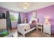 Bedroom with lilac colored walls, hardwood floors, a single bed, and lots of natural light at 7598 Jared Way, Littleton, CO 80125