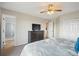 Bedroom featuring an ensuite bathroom, ceiling fan, and dresser with television at 7598 Jared Way, Littleton, CO 80125