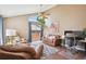 Bright living room featuring leather furniture, a ceiling fan, and sliding glass doors to the backyard at 7598 Jared Way, Littleton, CO 80125