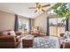 Comfortable living room with a vaulted ceiling, leather seating, and large windows with bright natural light at 7598 Jared Way, Littleton, CO 80125