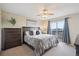 Bedroom featuring a sliding glass door to balcony, ceiling fan, and dark wood dresser at 7598 Jared Way, Littleton, CO 80125