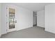 Airy bedroom with a glass door to the patio and neutral walls and carpet at 213 Washington St, Erie, CO 80516