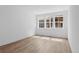 Bright bedroom with wood floors and three large windows providing plenty of natural light at 213 Washington St, Erie, CO 80516