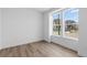 Bright bedroom featuring hardwood floors and large windows at 213 Washington St, Erie, CO 80516