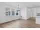 Bright dining room featuring wood floors, white walls, and lots of natural light from the three large windows at 213 Washington St, Erie, CO 80516