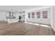 Open-concept living space featuring hardwood floors and a modern kitchen with an island at 213 Washington St, Erie, CO 80516